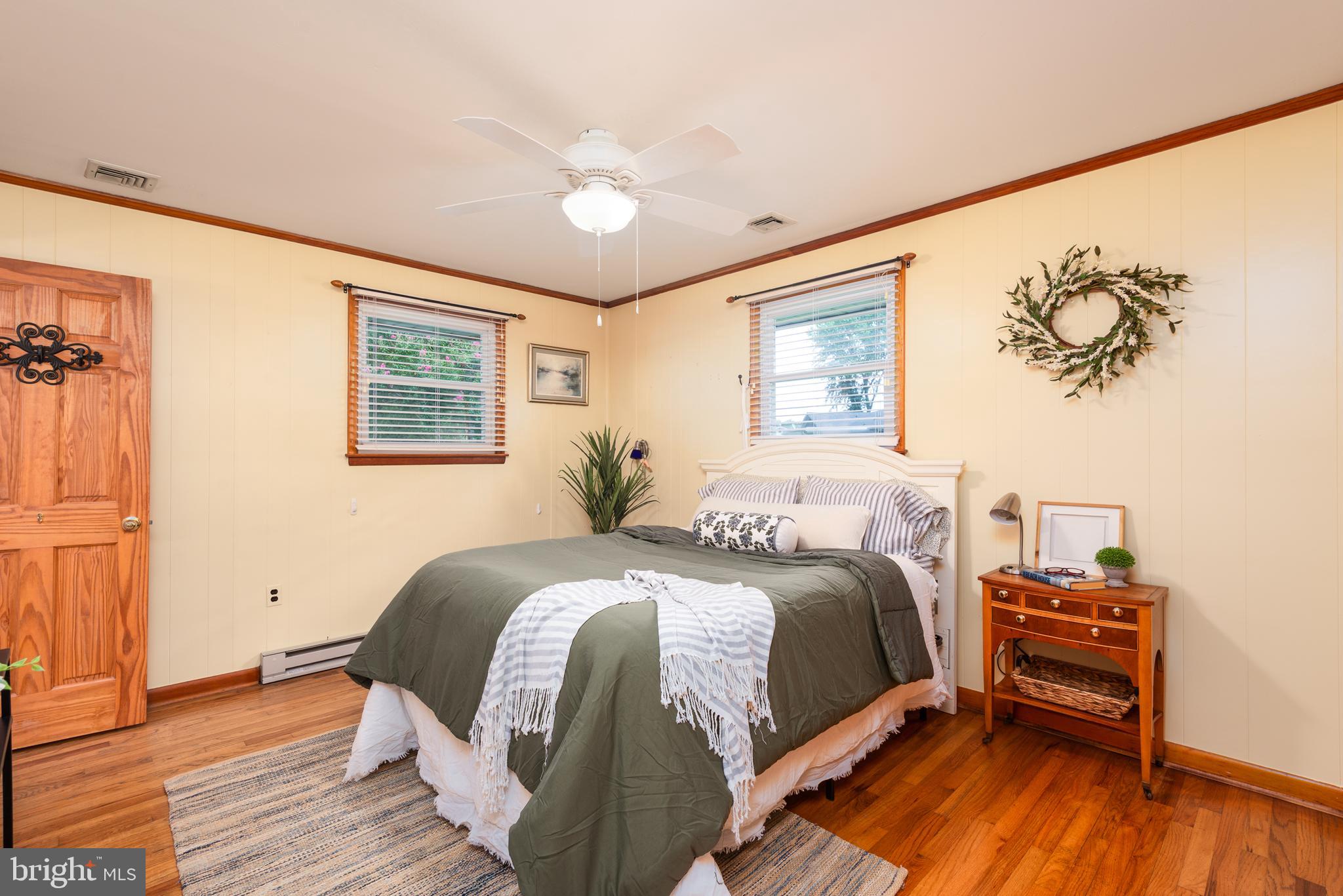 1401 Calvert Road Chester, MD 21619 - Photo 16 of 33 a bedroom with a bed and wooden floor