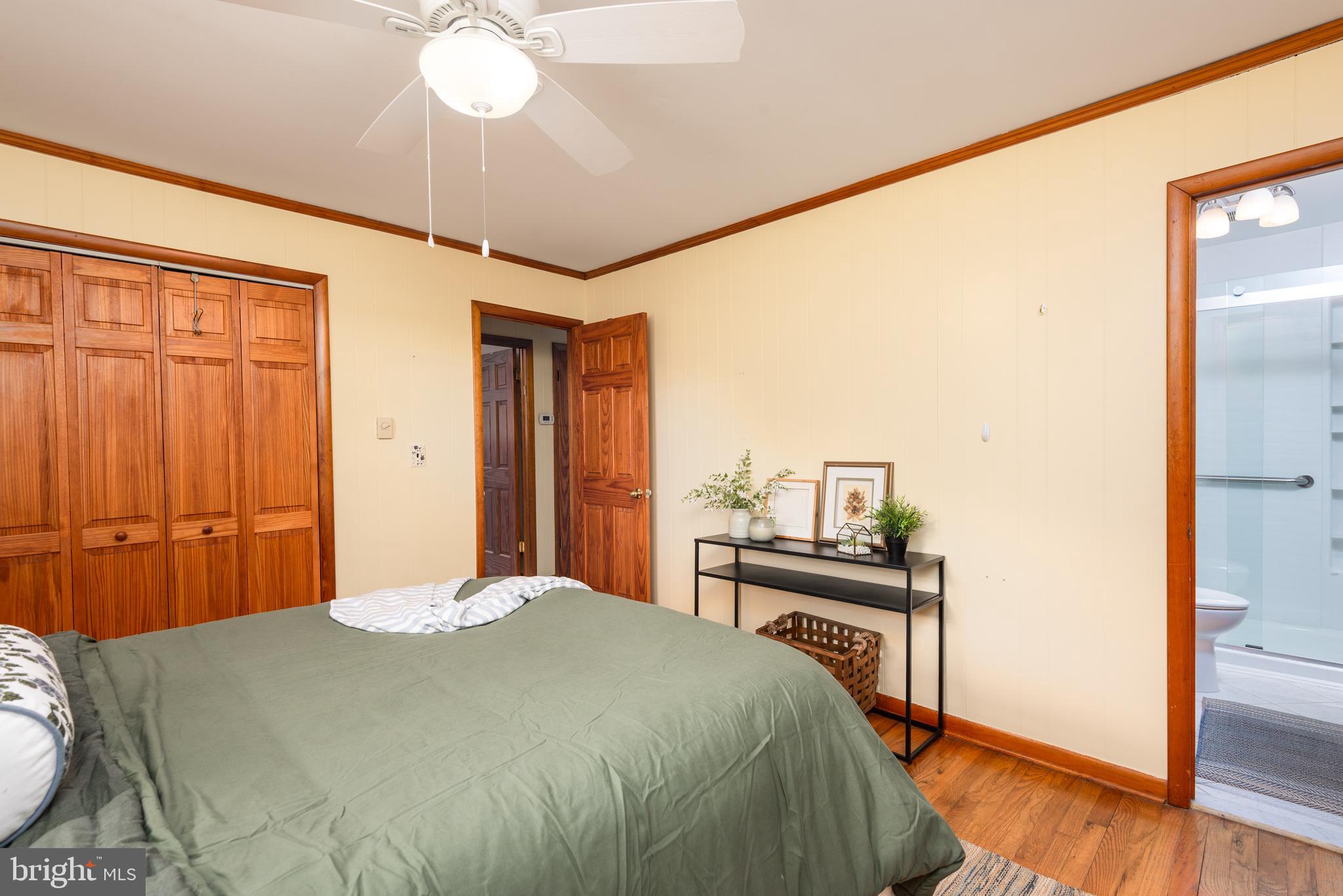 1401 Calvert Road Chester, MD 21619 - Photo 17 of 33 a bedroom with a bed and a chandelier