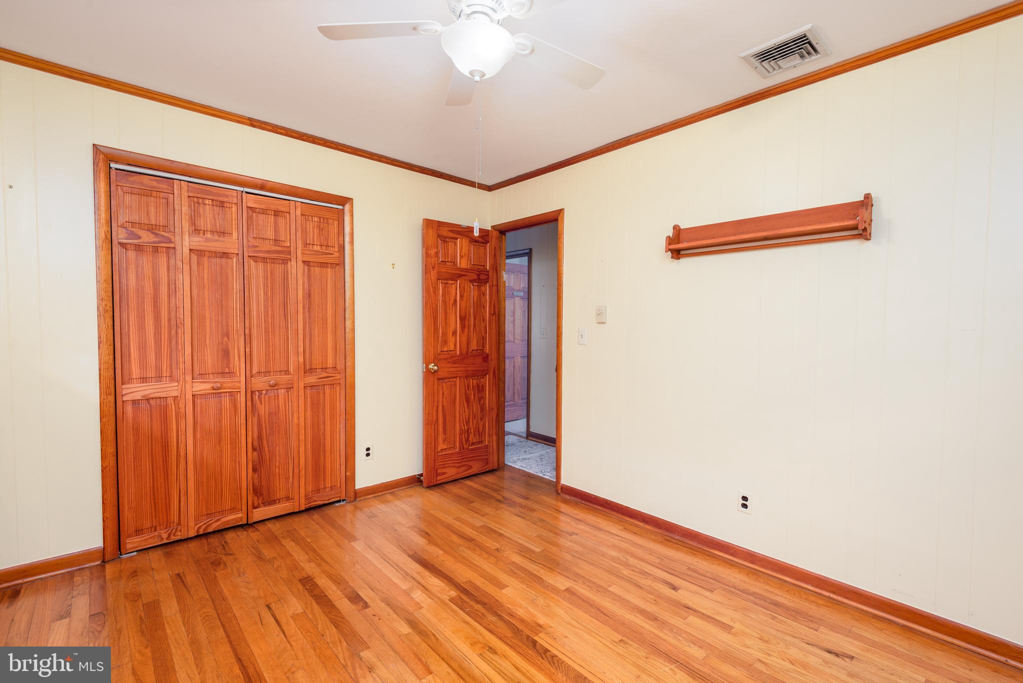1401 Calvert Road Chester, MD 21619 - Photo 20 of 33 an empty room with wooden floor and closet