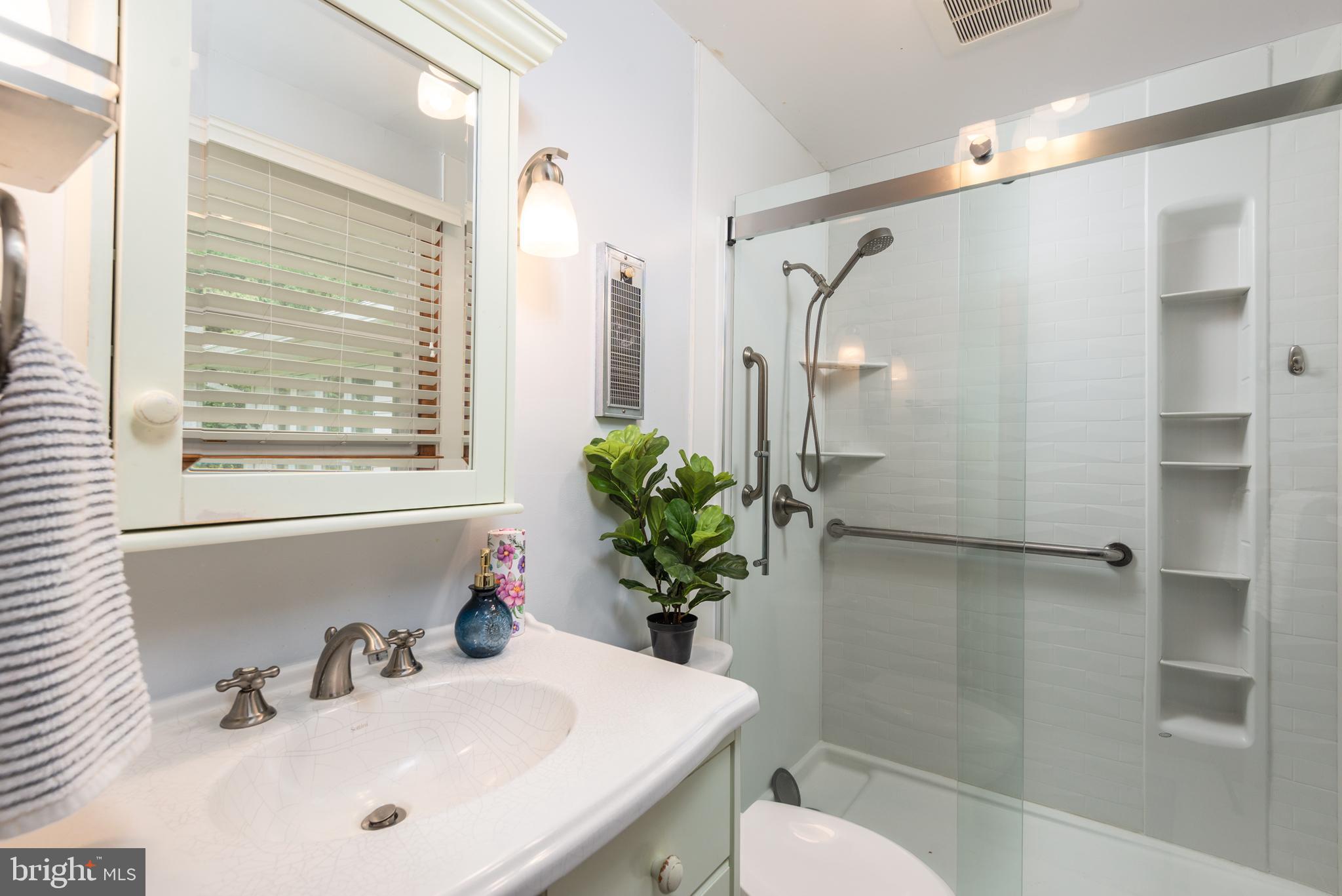 1401 Calvert Road Chester, MD 21619 - Photo 21 of 33 a bathroom with a sink toilet and shower
