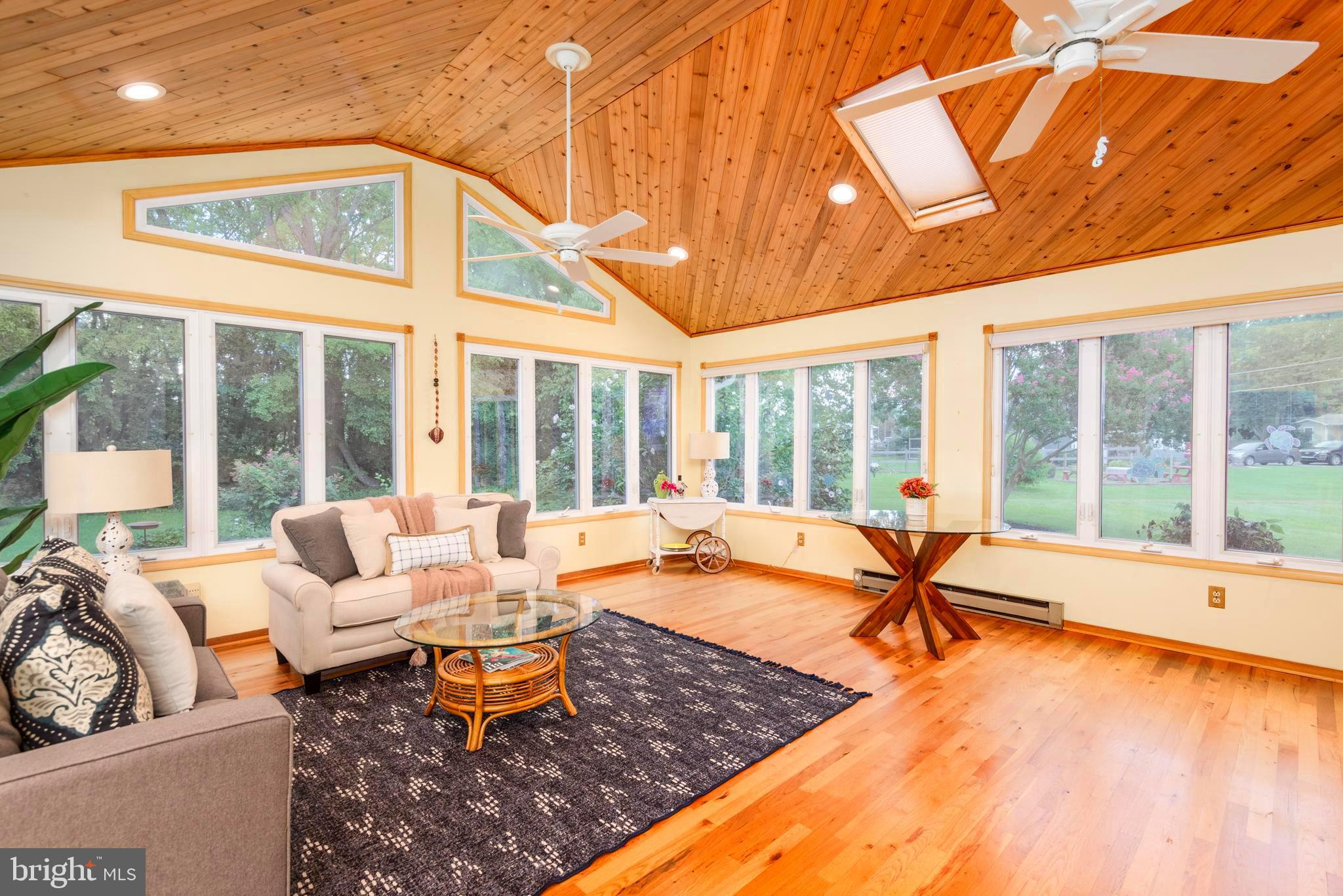 1401 Calvert Road Chester, MD 21619 - Photo 3 of 33 a living room with furniture and floor to ceiling windows