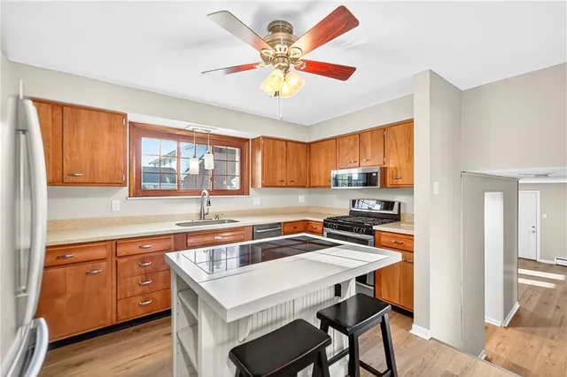 a kitchen with a stove a sink and a refrigerator