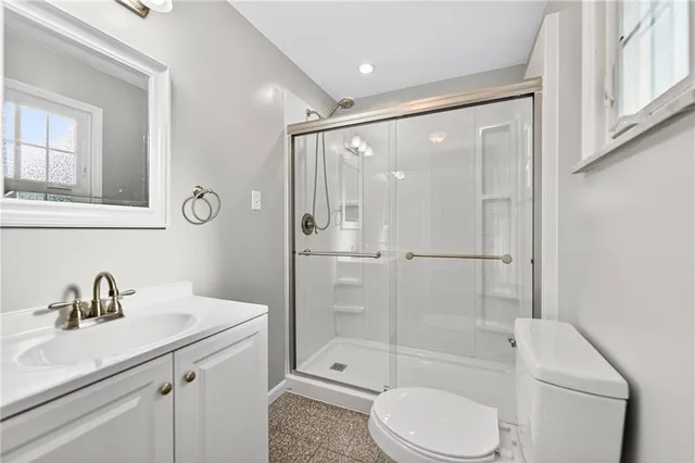 a bathroom with a sink a toilet and shower