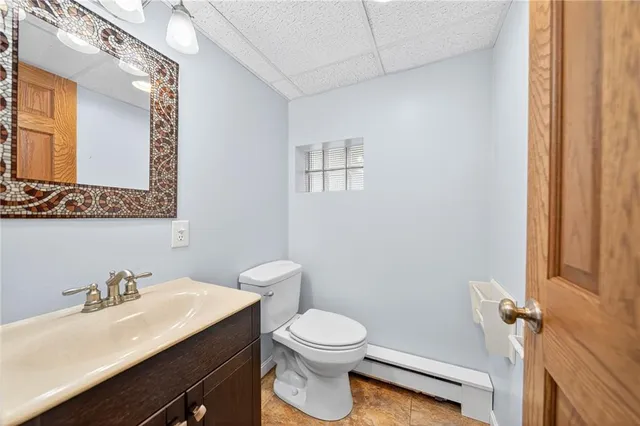 a bathroom with a sink a toilet and mirror