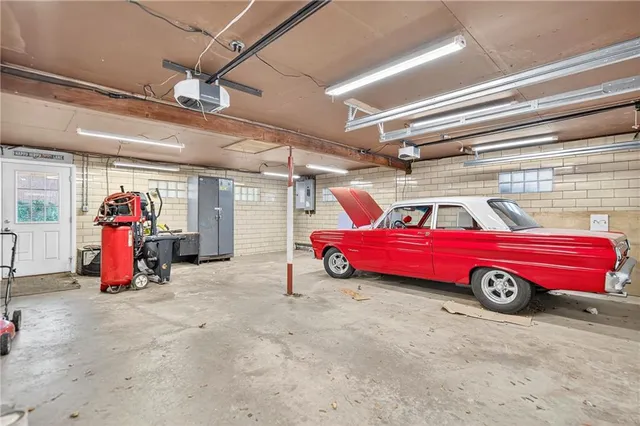 a view of a red car is parked in a garage