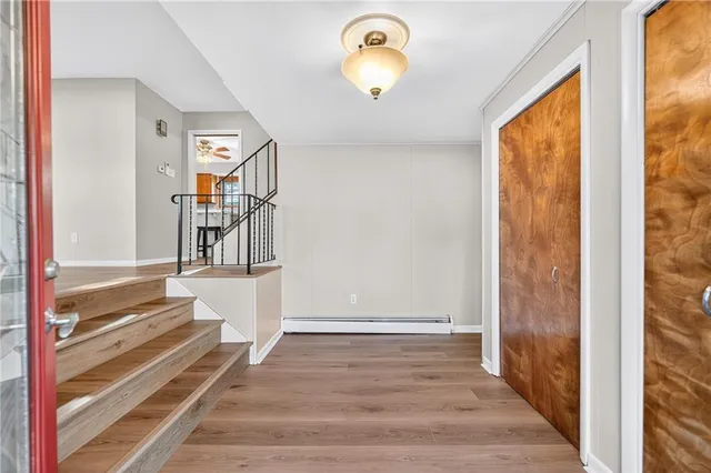 a view of entryway and hall with wooden floor
