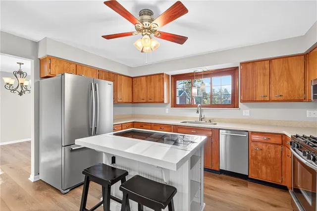 a kitchen with stainless steel appliances a sink and stove