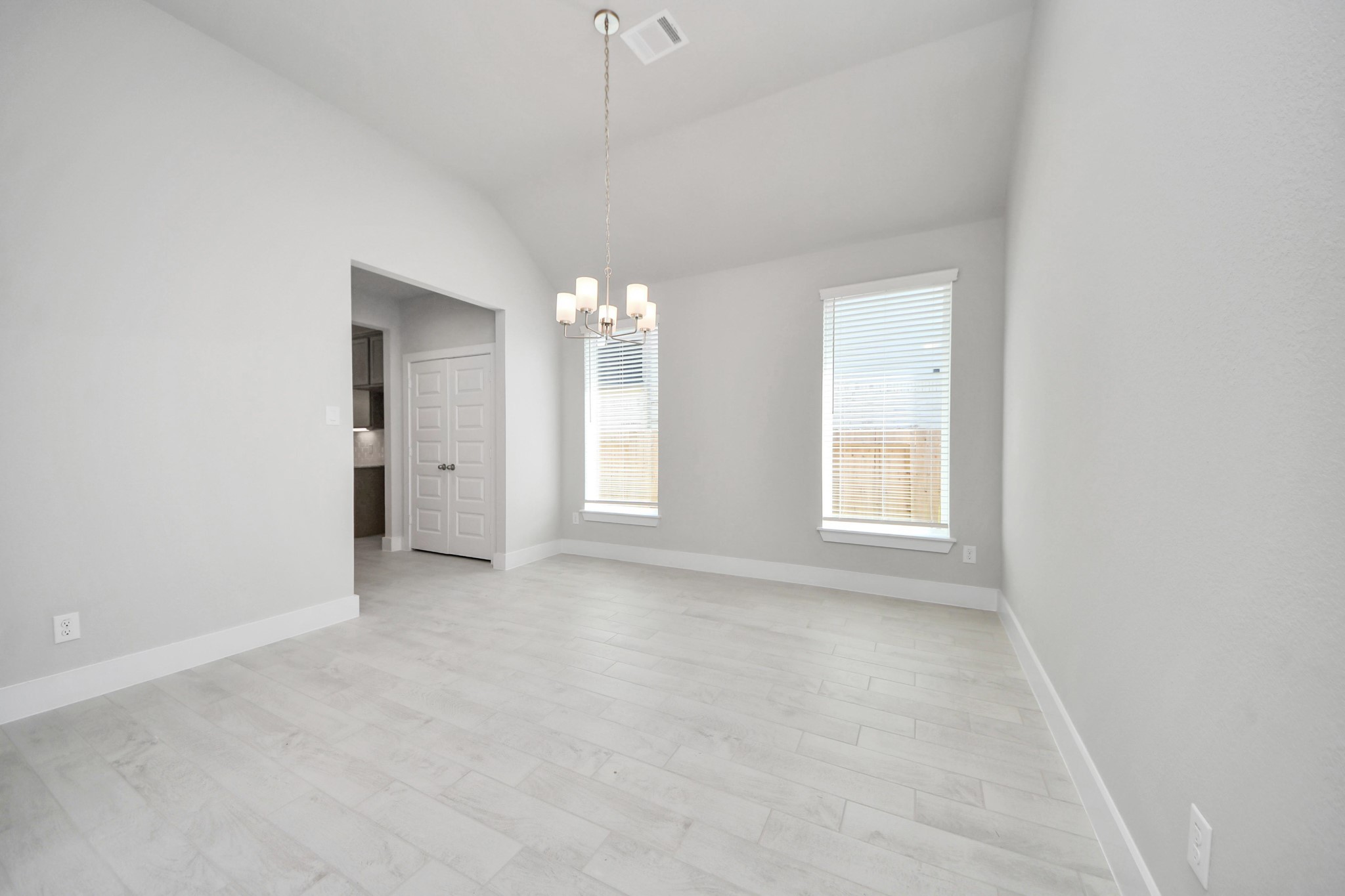 3042 Native Spg Drive Spring, TX 77373 - Photo 5 of 32 An inviting dining space seamlessly woven into the open concept, connecting the family room and kitchen. Revel in the stunning floors, soothing paint palette, and the crowning touch of a sleek chandelier – a perfect setting for shared meals and cherished moments. Sample photo of completed home with similar floor plan. Actual colors and selections may vary.