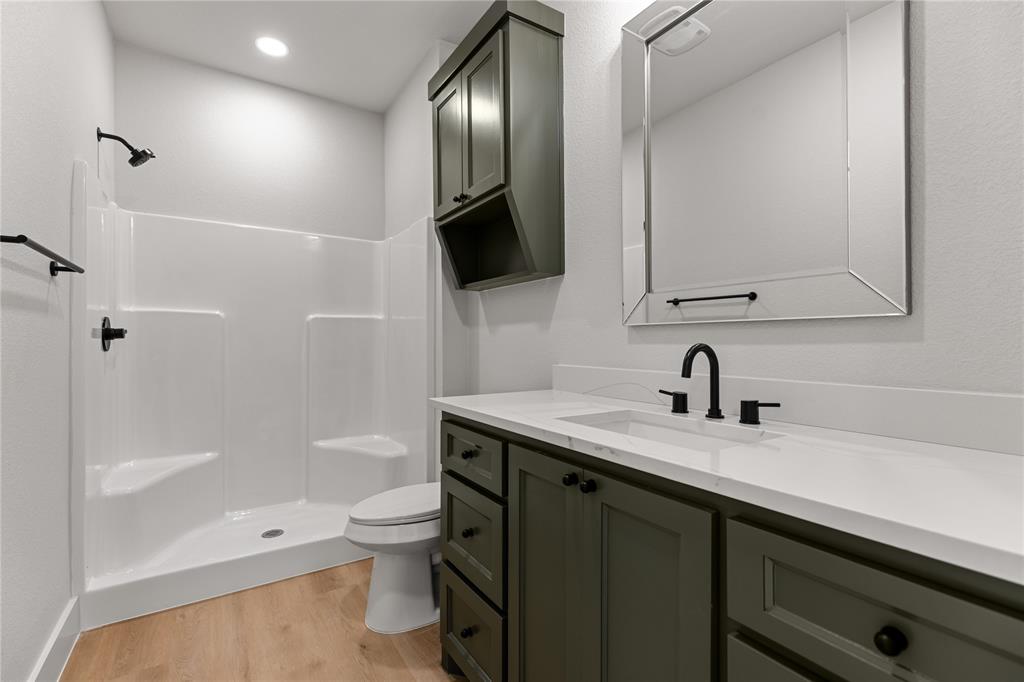 100 Arthur Avenue McGregor, TX 76657 - Photo 12 of 17 Full bath with light wood finished floors, vanity, and a shower stall