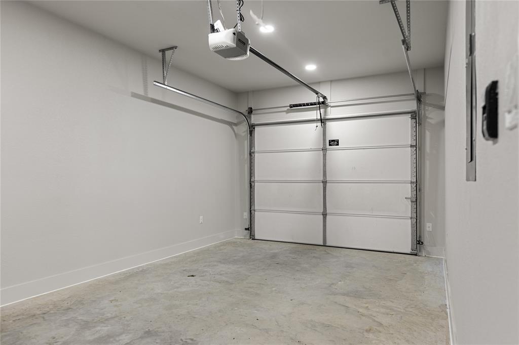 100 Arthur Avenue McGregor, TX 76657 - Photo 13 of 17 Garage with a garage door opener and baseboards