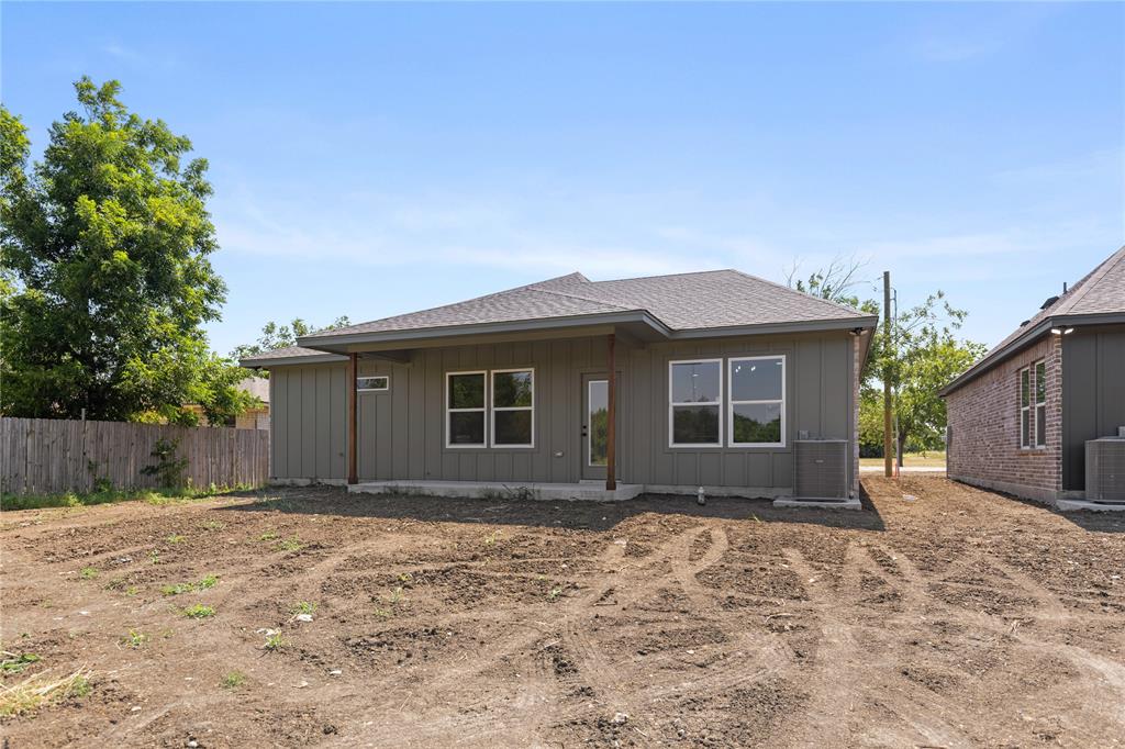 100 Arthur Avenue McGregor, TX 76657 - Photo 3 of 17 Rear view of house featuring board and batten siding, roof with shingles, and a patio
