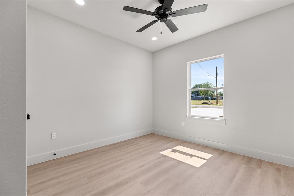 100 Arthur Avenue McGregor, TX 76657 - Photo 7 of 17 Empty room with light wood-type flooring, recessed lighting, and a ceiling fan