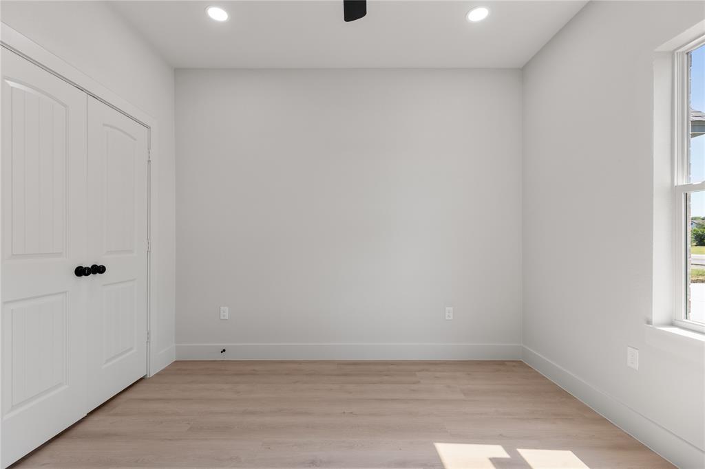 100 Arthur Avenue McGregor, TX 76657 - Photo 8 of 17 Empty room with light wood finished floors and recessed lighting