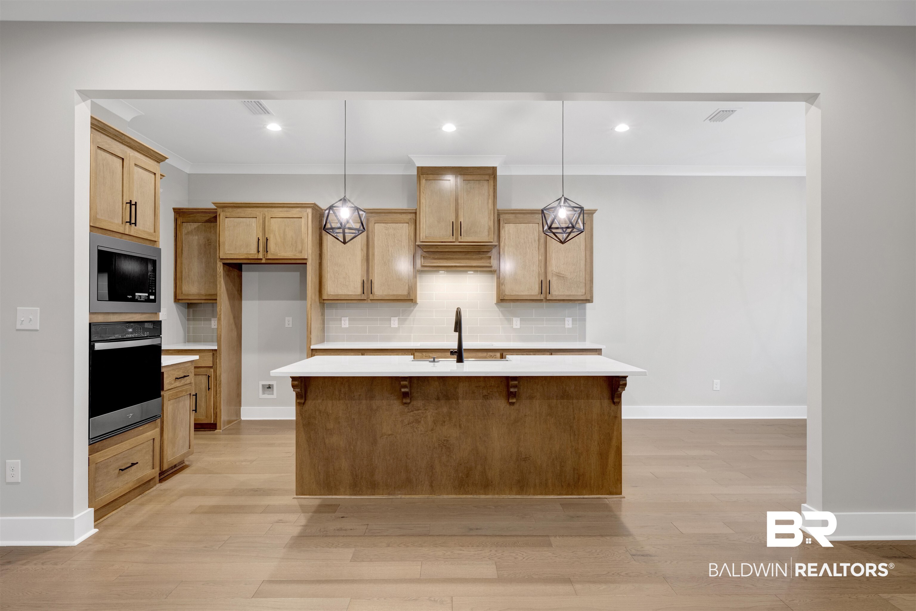 27371 Patch Pl Loop Daphne, AL 36526 - Photo 38 of 63 Kitchen featuring light wood-finish cabinetry, white countertops, stainless steel built-in appliances, and a central island with pendant lighting