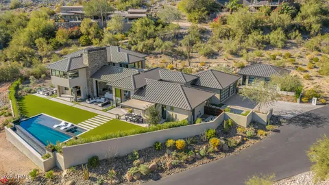 an aerial view of a house with a swimming pool