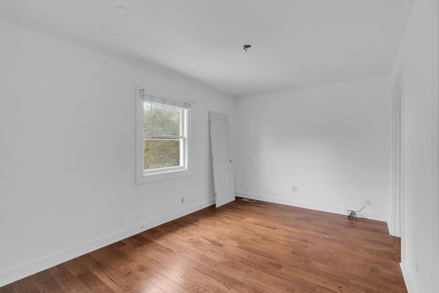 19000 Overlook Road Los Gatos, CA 95030 - Photo 18 of 56 an empty room with wooden floor and windows