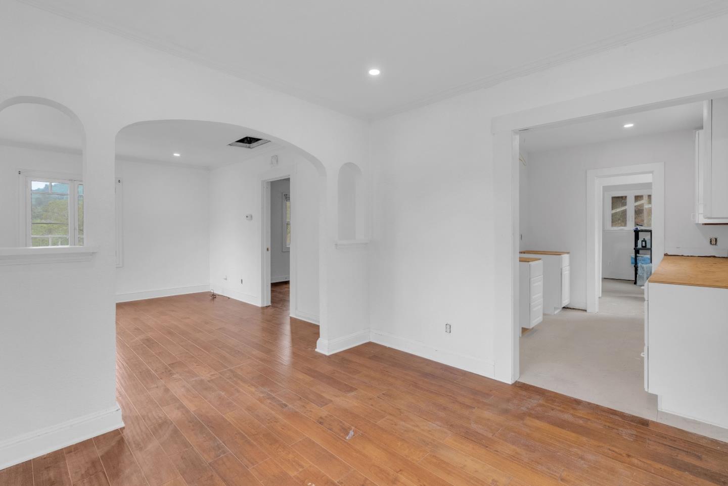 19000 Overlook Road Los Gatos, CA 95030 - Photo 23 of 56 a view of empty room with wooden floor and a kitchen