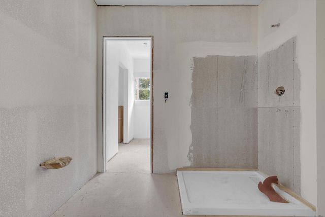 a bathroom with a tub and shower