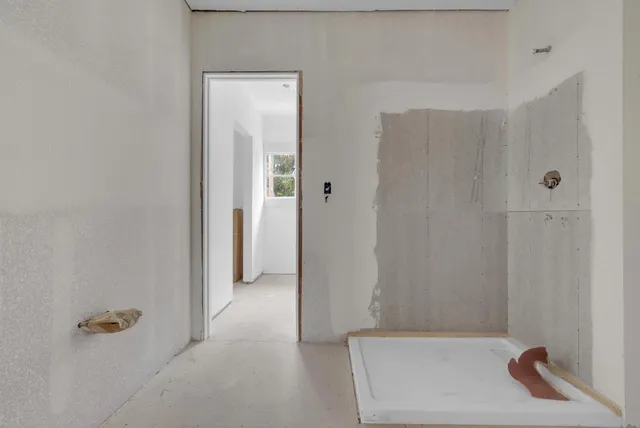 a bathroom with a tub and shower