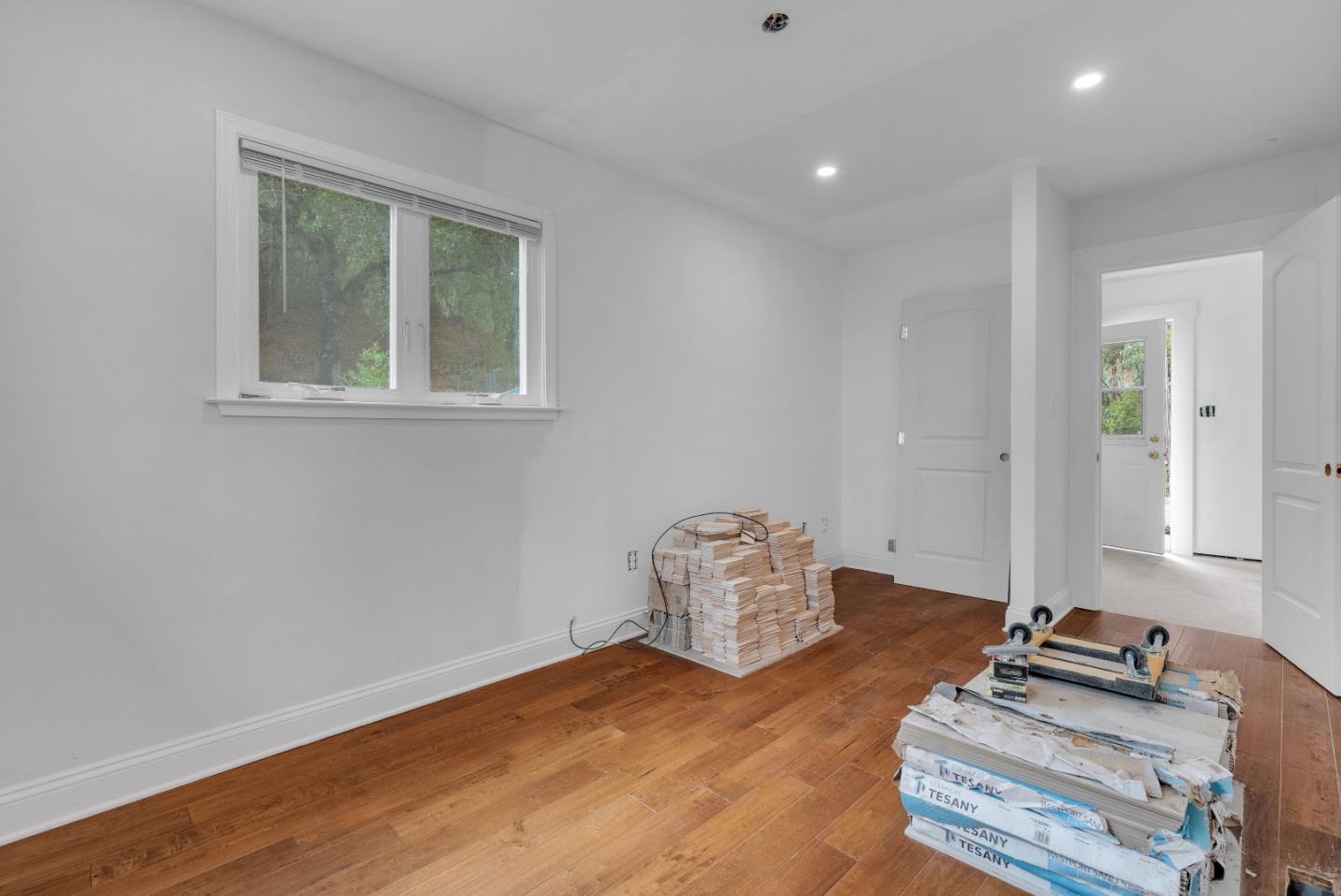 19000 Overlook Road Los Gatos, CA 95030 - Photo 28 of 56 a room with wooden floor and cabinets