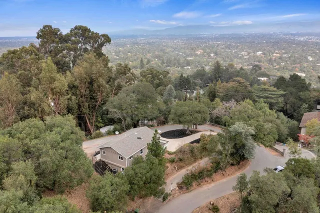 an aerial view of a house with a yard and a garage