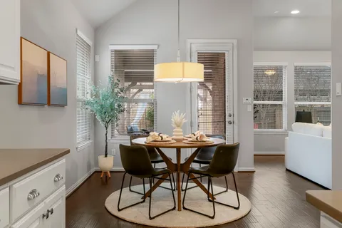 a dining room with furniture and window