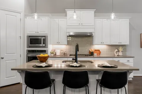 a kitchen with a sink stove and cabinets