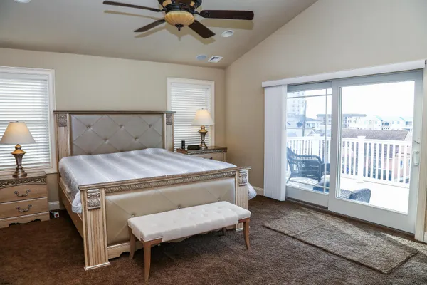 a bedroom with a bed and large window