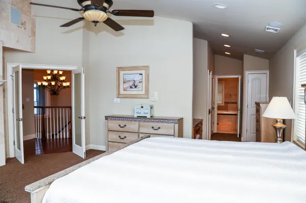 a bedroom with a bed and a chandelier