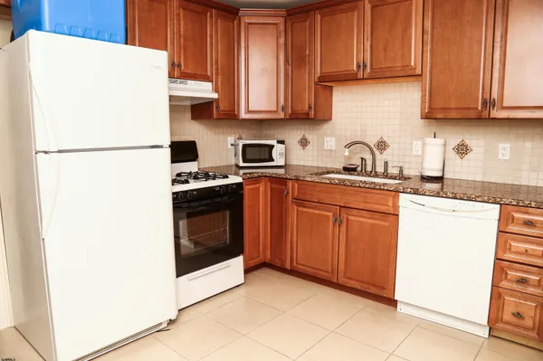 a view of a kitchen with white cabinets