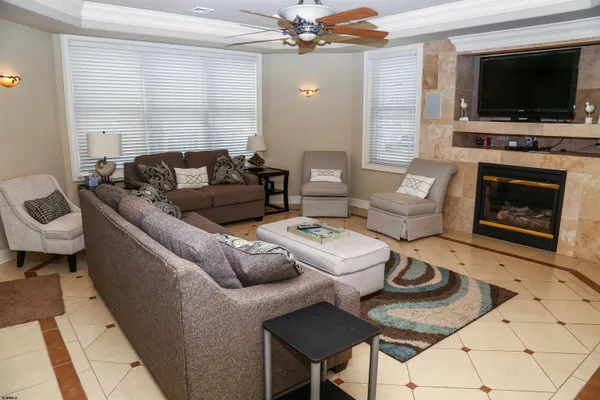 a living room with furniture a flat screen tv and a fireplace