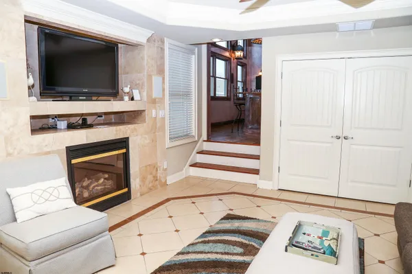 a living room with a fireplace and a flat screen tv