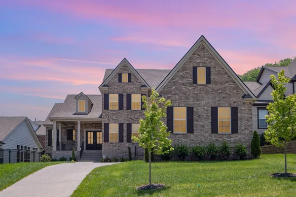 a front view of a house with a yard