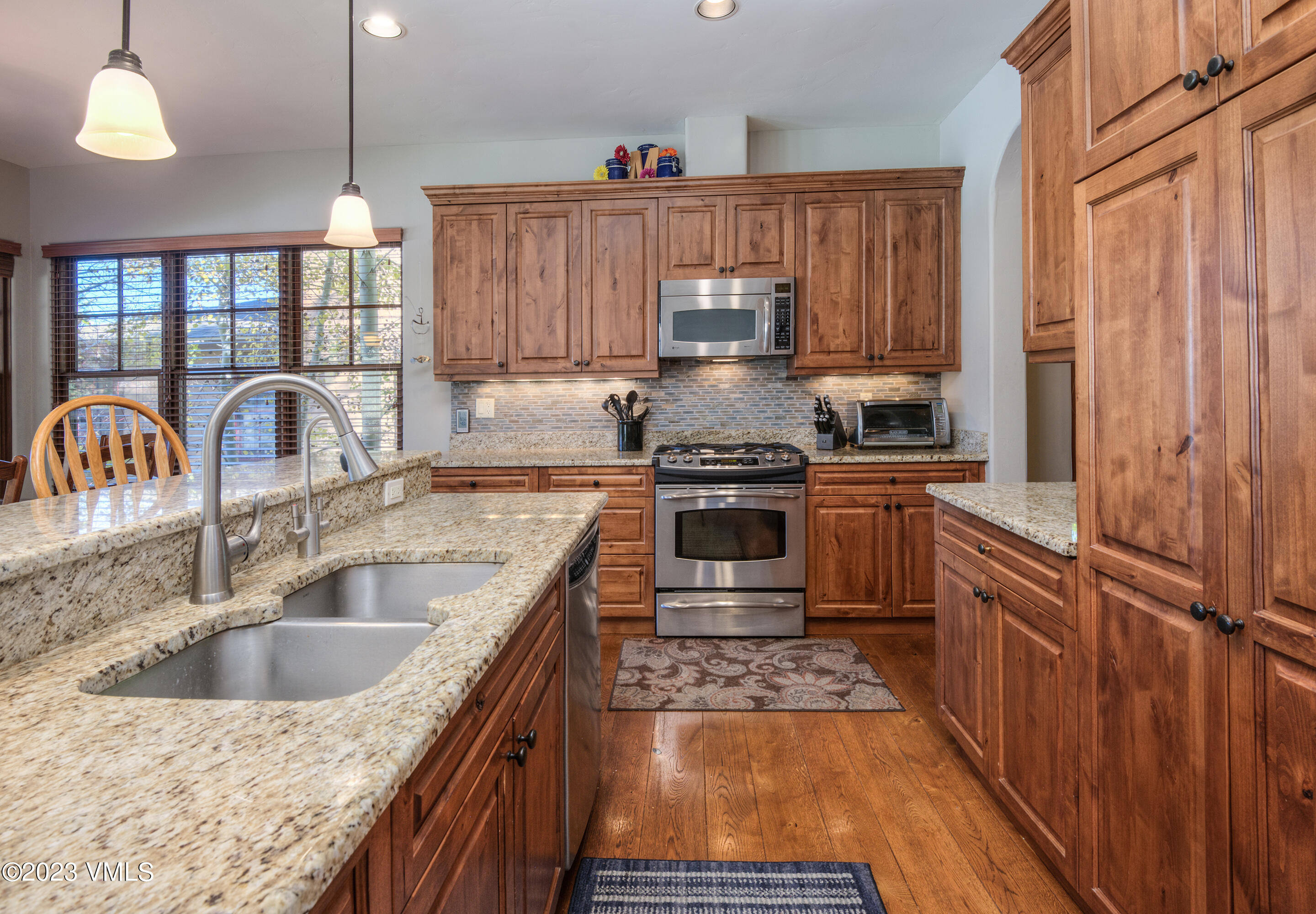 346 Palmer Loop Eagle, CO 81631 - Photo 11 of 63 a kitchen with kitchen island granite countertop a stove and a sink