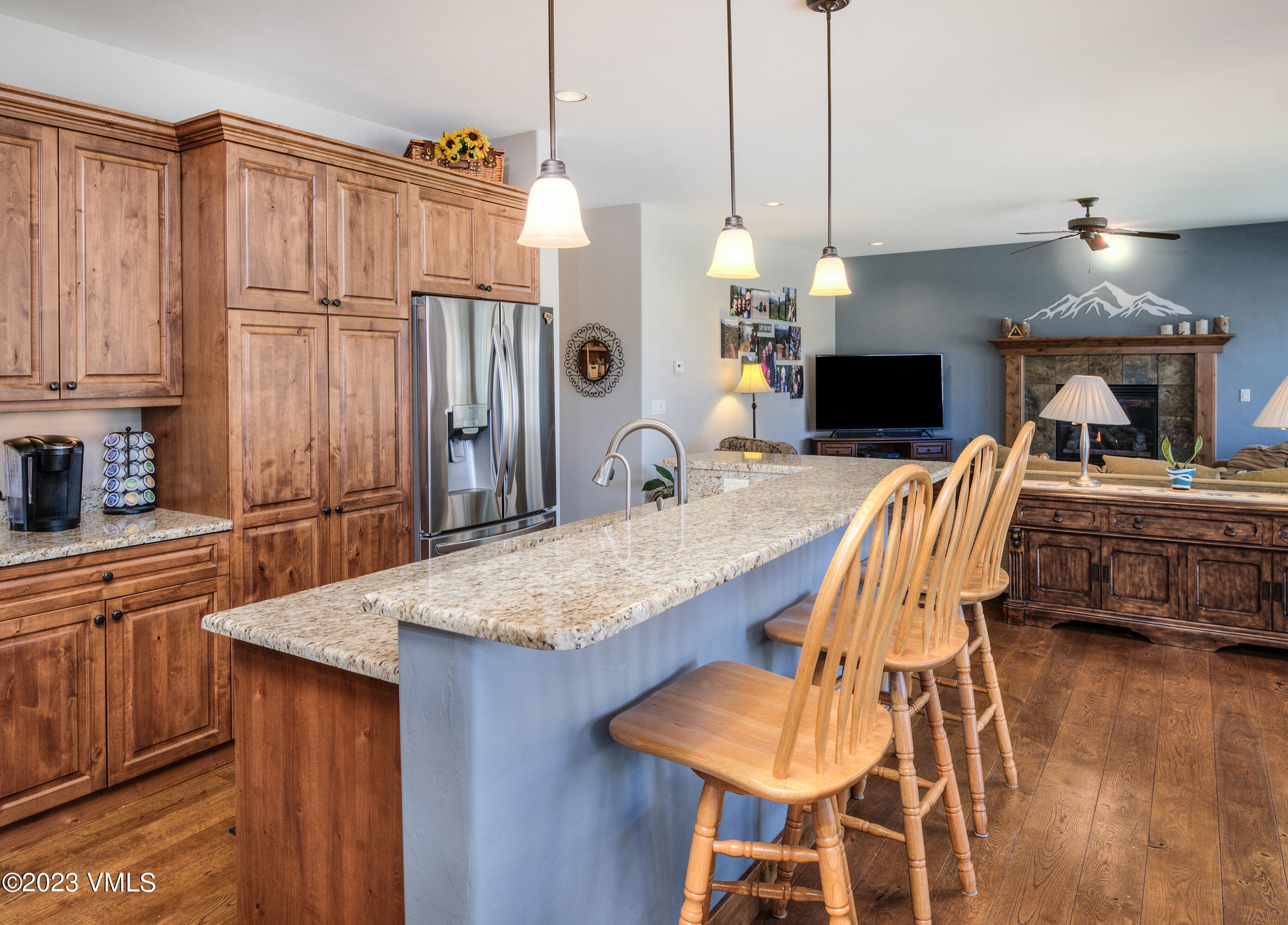 346 Palmer Loop Eagle, CO 81631 - Photo 12 of 63 a kitchen with stainless steel appliances kitchen island granite countertop a table chairs and a refrigerator
