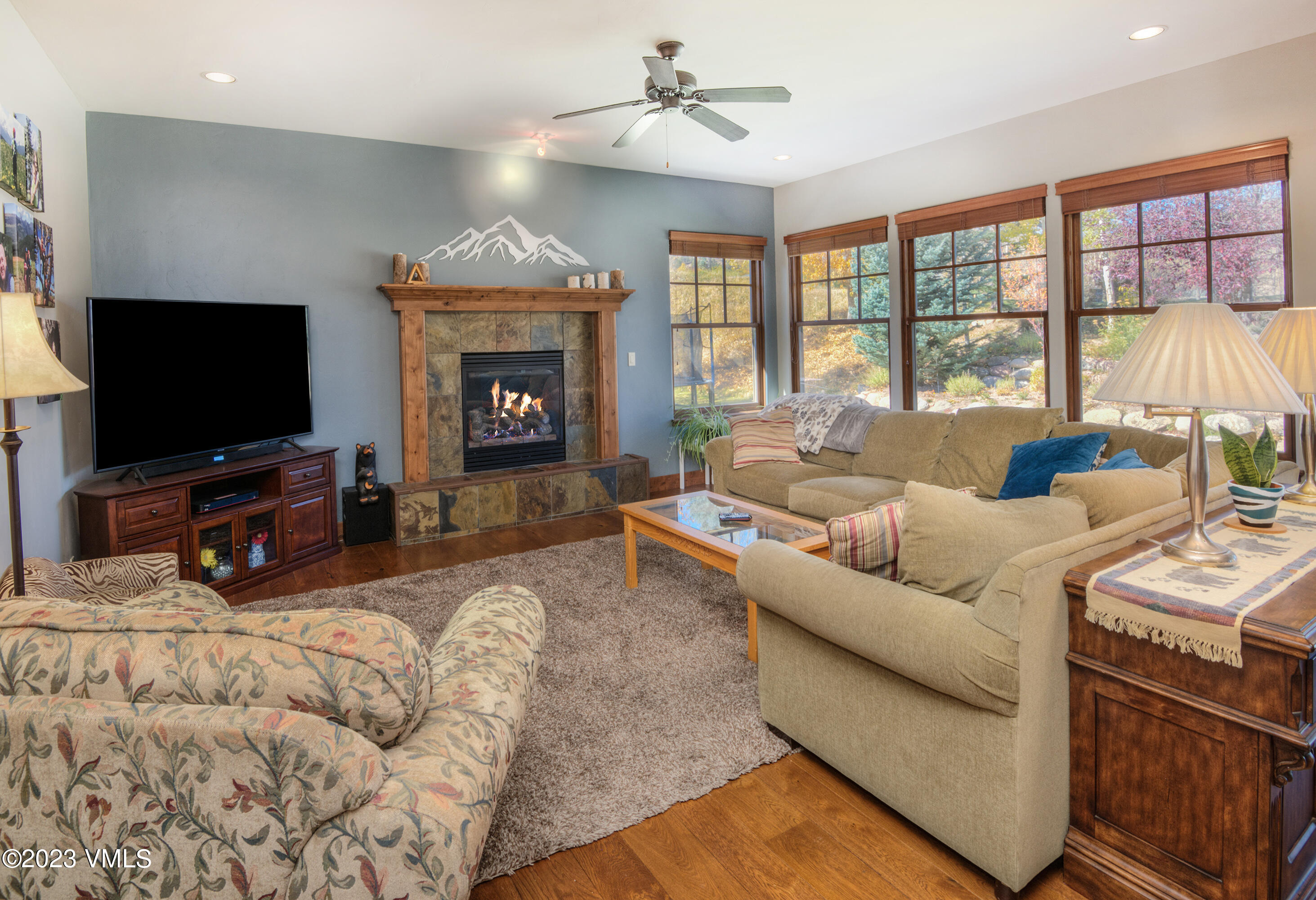 346 Palmer Loop Eagle, CO 81631 - Photo 18 of 63 a living room with furniture a fireplace and a flat screen tv