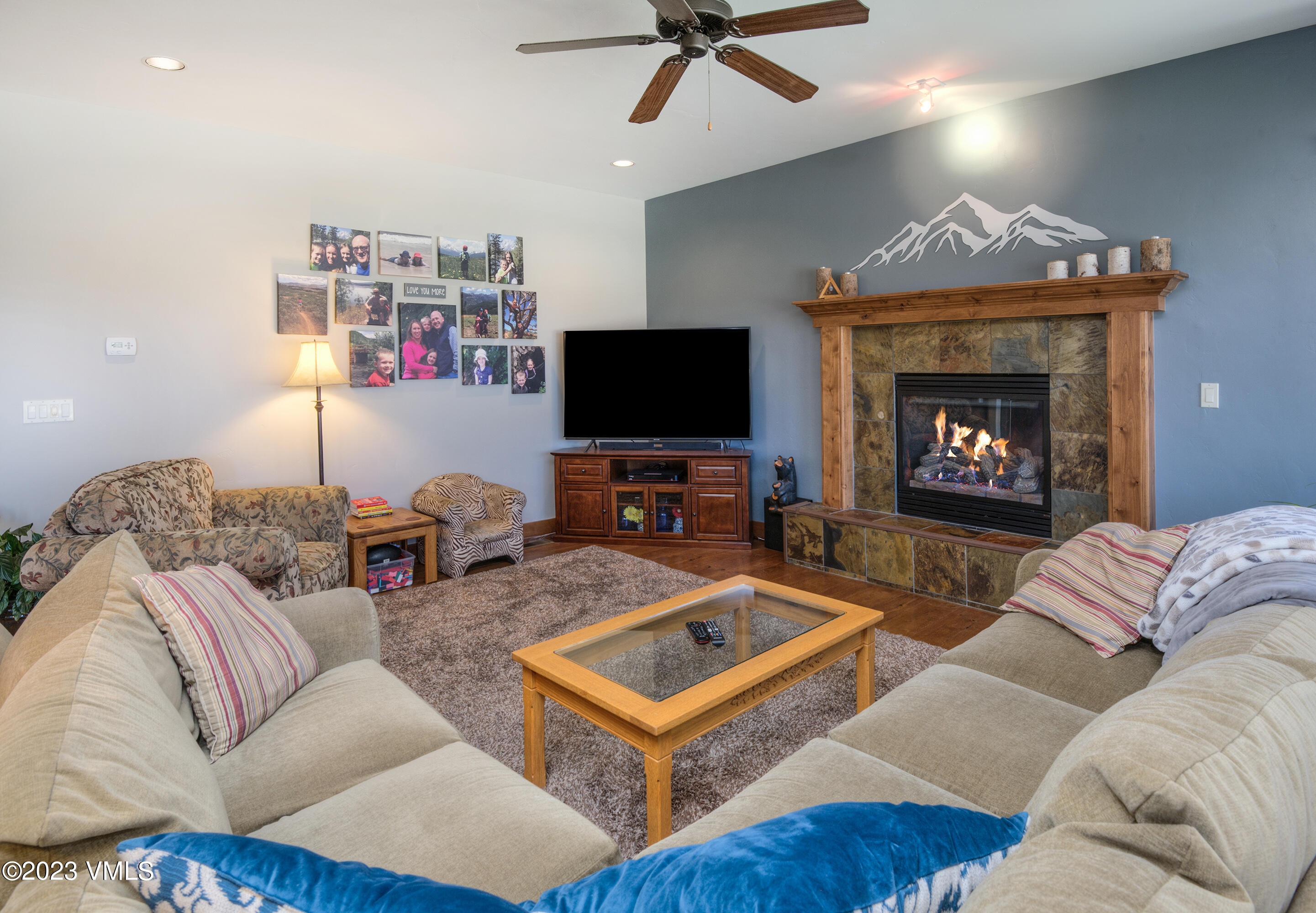 346 Palmer Loop Eagle, CO 81631 - Photo 19 of 63 a living room with furniture a flat screen tv and a fireplace