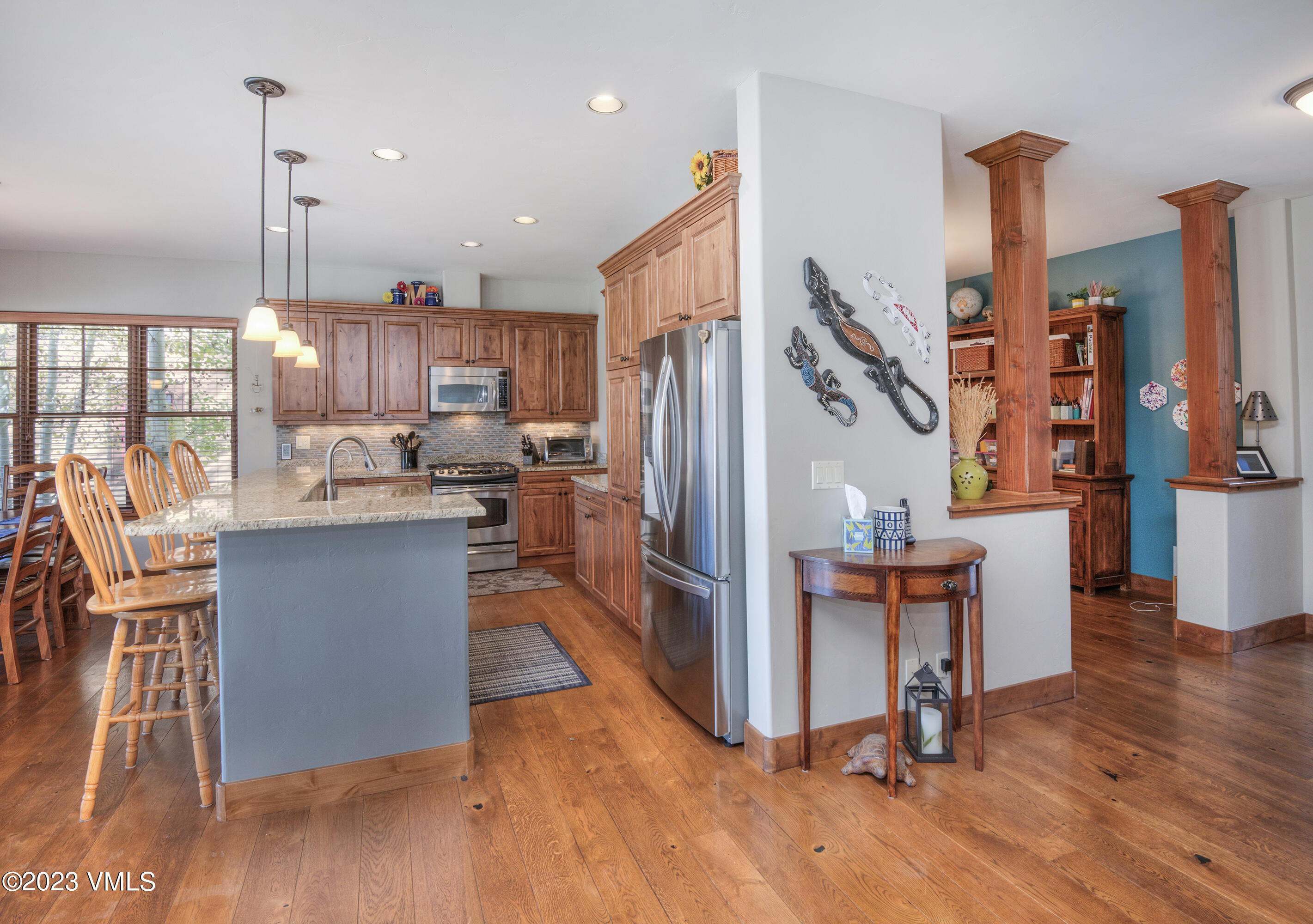 346 Palmer Loop Eagle, CO 81631 - Photo 9 of 63 a kitchen with stainless steel appliances granite countertop a refrigerator a stove and a wooden floors