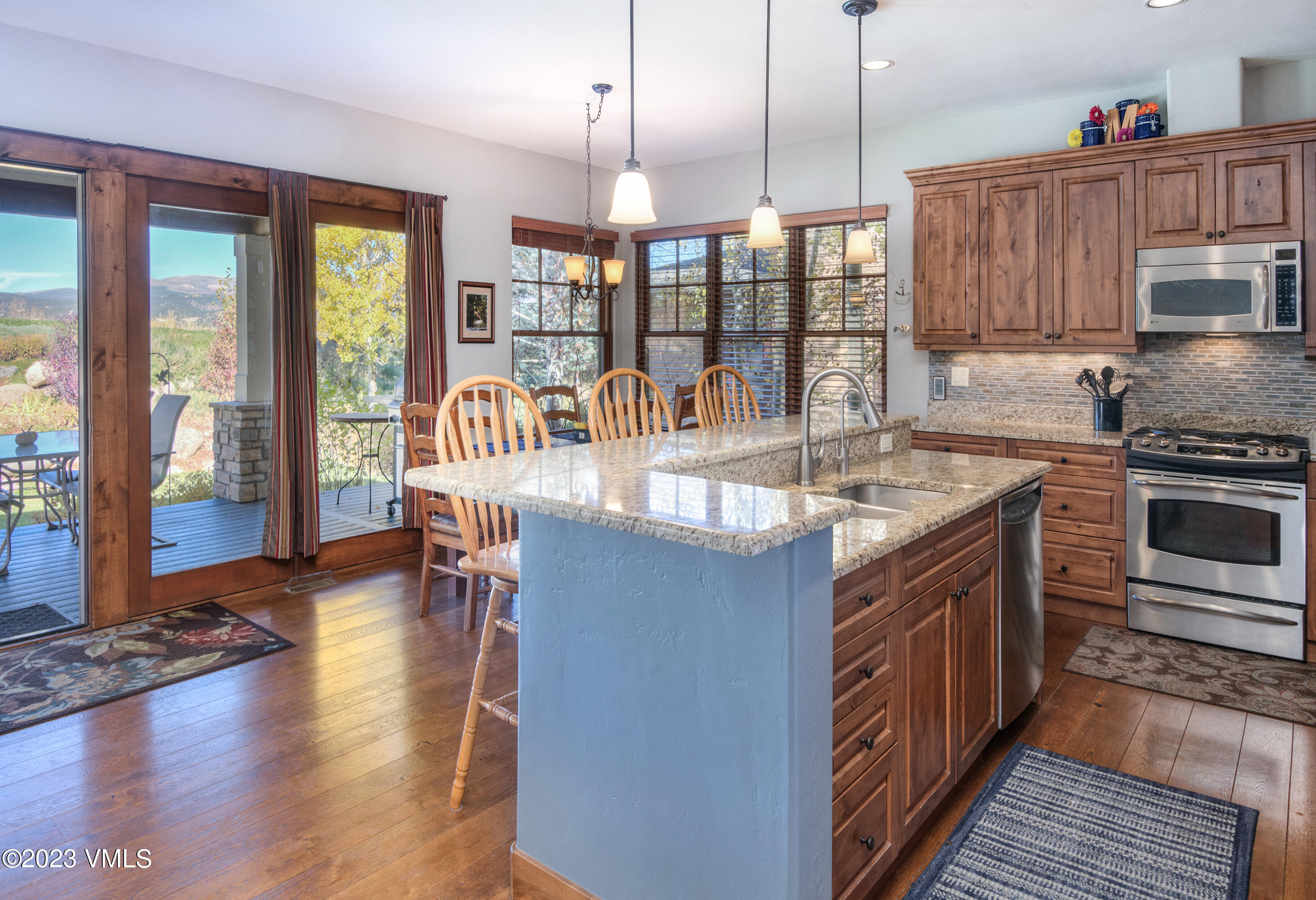 346 Palmer Loop Eagle, CO 81631 - Photo 10 of 63 a kitchen with stainless steel appliances granite countertop a stove and a wooden floors