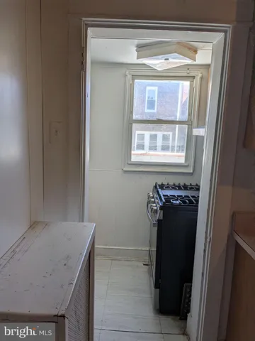 a view of a hallway with entryway wooden floor and staircase