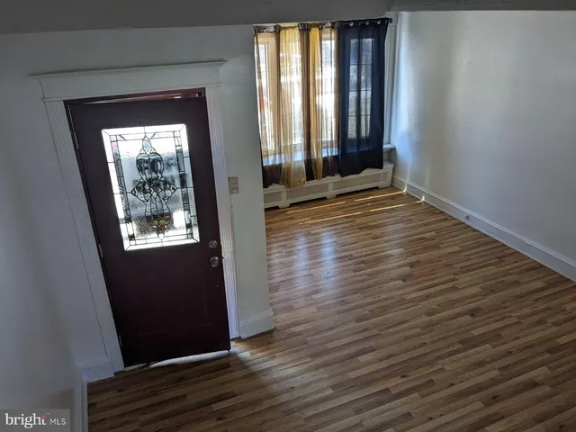 a view of front door and wooden floor