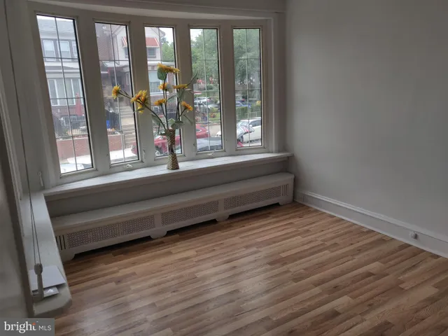 a view of room with window and wooden floor