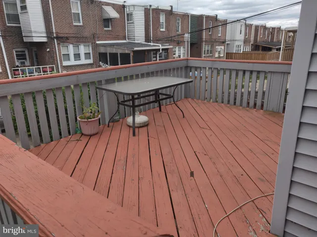 a view of a hallway with wooden floor and a fireplace