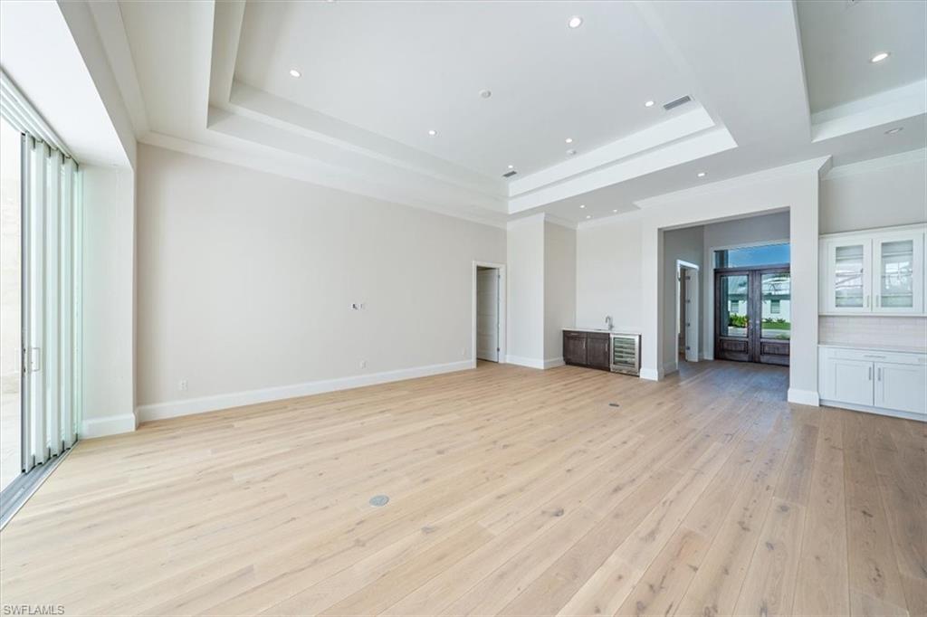 23511 Coconut Road Estero, FL 34134 - Photo 13 of 50 a view of an empty room with wooden floor and a window