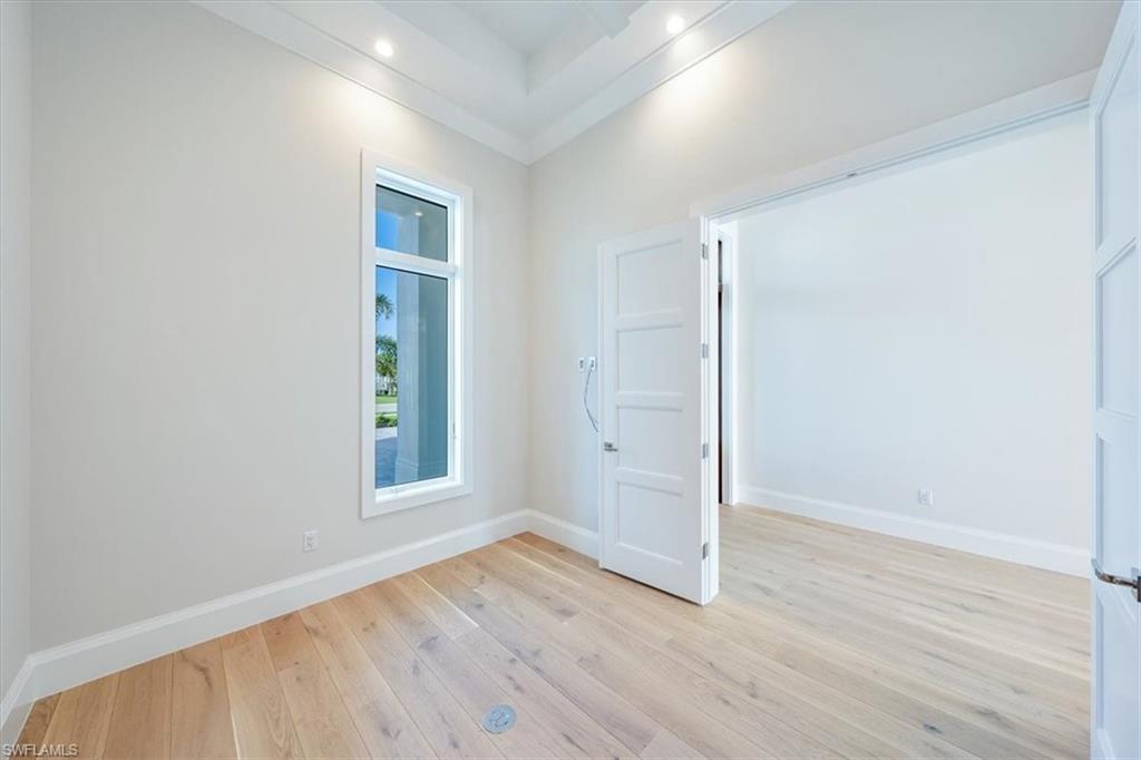 23511 Coconut Road Estero, FL 34134 - Photo 17 of 50 an empty room with wooden floor and windows