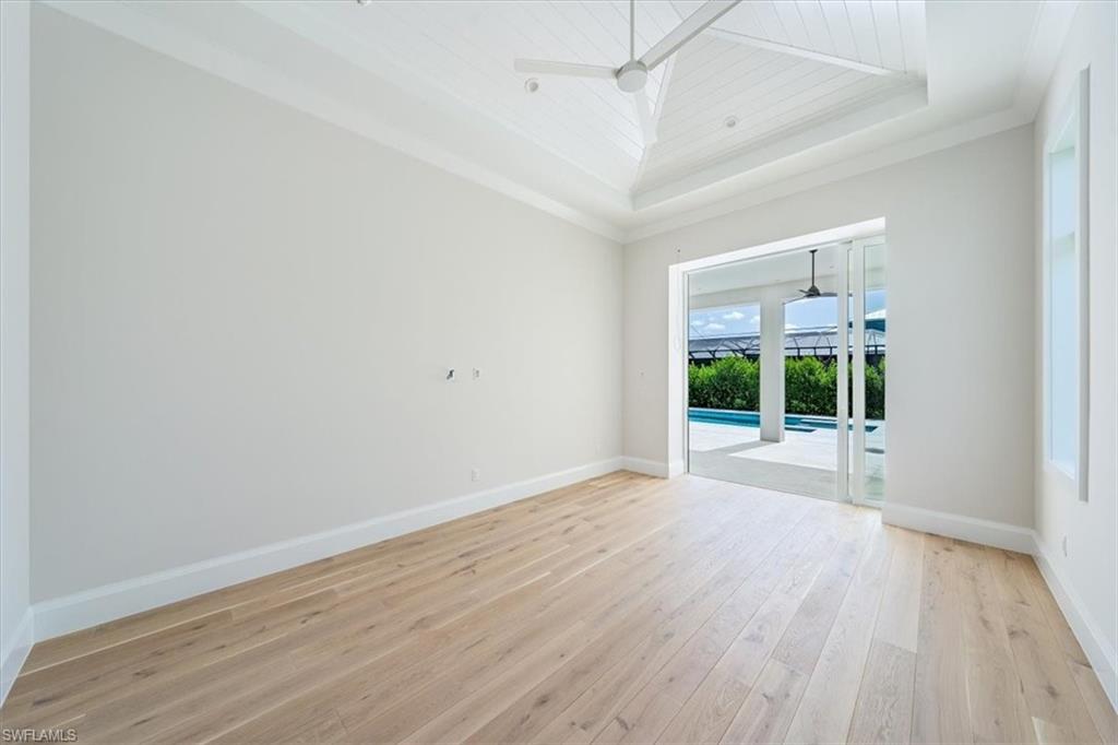 23511 Coconut Road Estero, FL 34134 - Photo 19 of 50 wooden floor in an empty room with a window