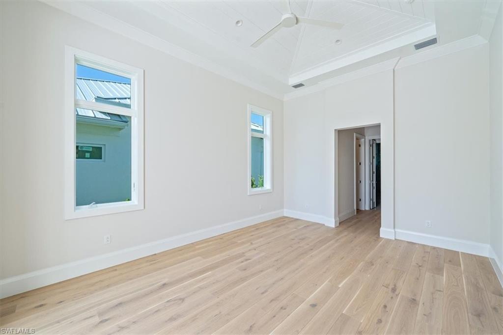 23511 Coconut Road Estero, FL 34134 - Photo 20 of 50 a view of an empty room with wooden floor and a window