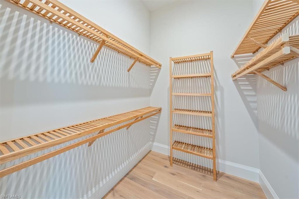23511 Coconut Road Estero, FL 34134 - Photo 21 of 50 a view of walk in closet with empty racks