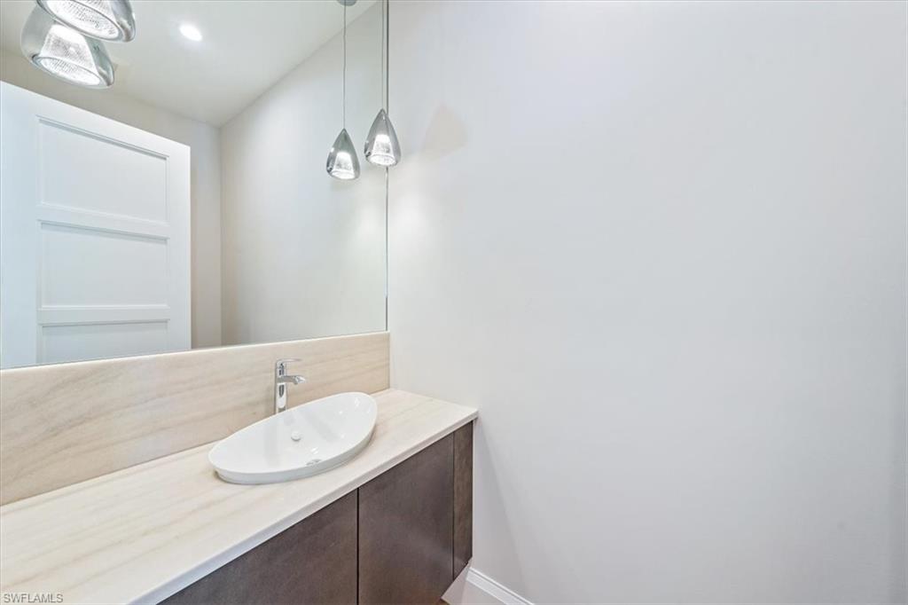 23511 Coconut Road Estero, FL 34134 - Photo 24 of 50 a bathroom with a granite countertop sink and a mirror