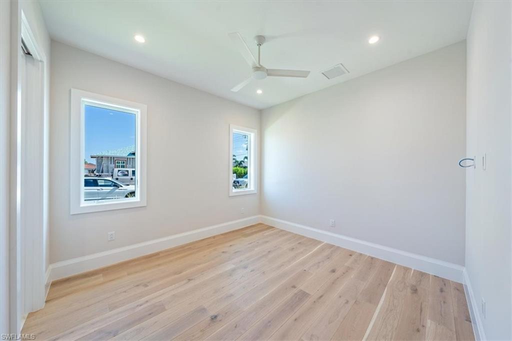 23511 Coconut Road Estero, FL 34134 - Photo 25 of 50 wooden floor in an empty room with a window